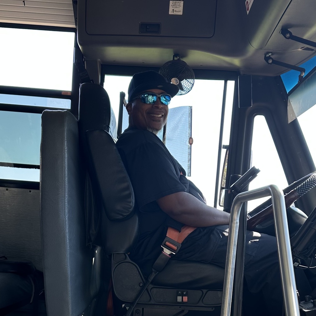 school bus driver smiling for photo for school bus driver appreciation week 