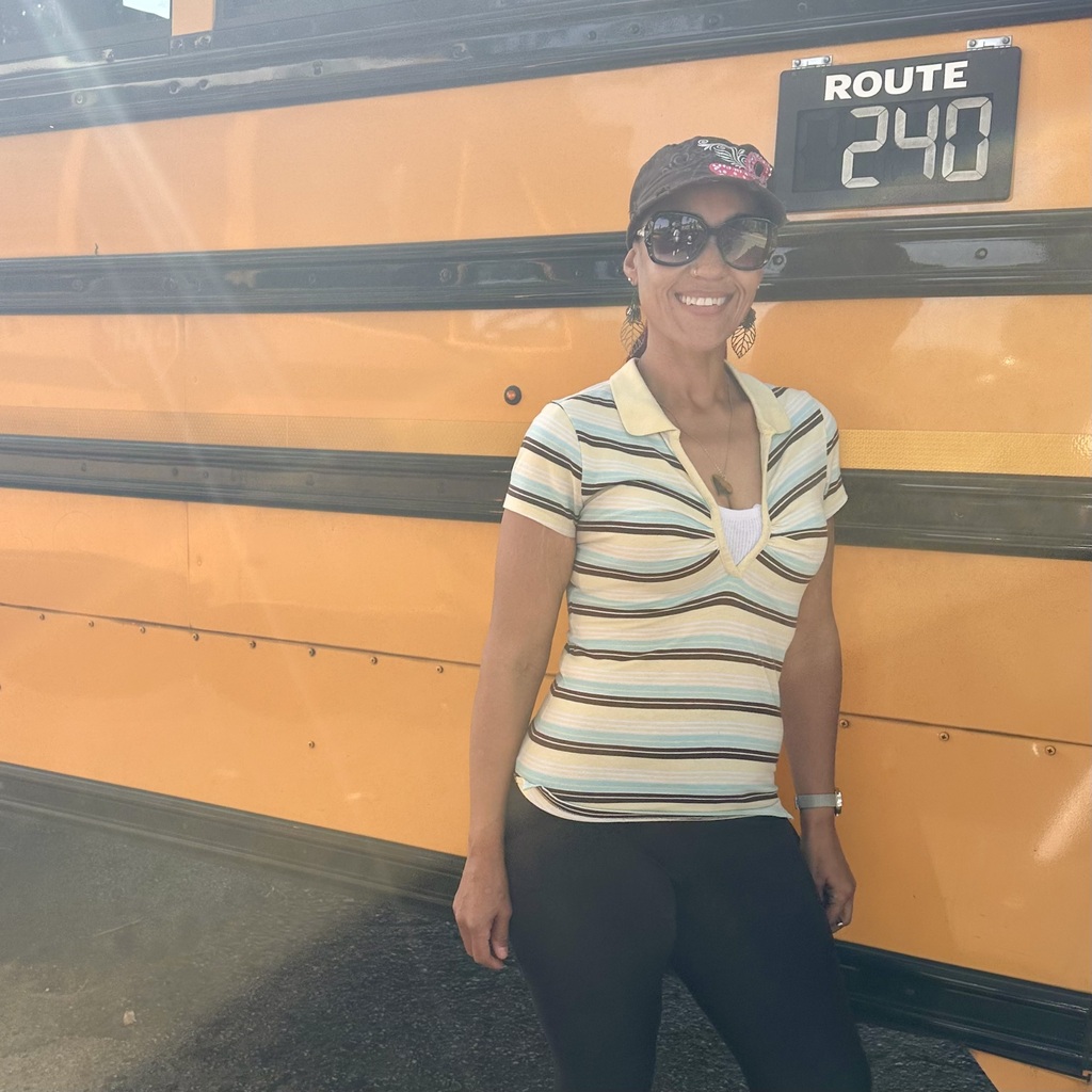 school bus driver smiling for photo for school bus driver appreciation week 