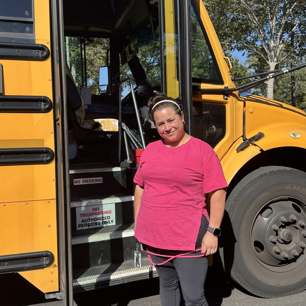 school bus driver smiling for photo for school bus driver appreciation week 