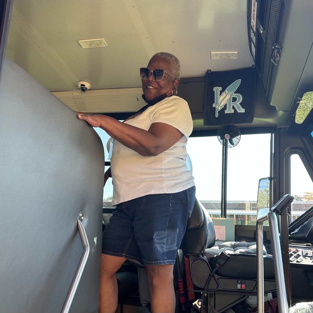 school bus driver smiling for photo for school bus driver appreciation week 