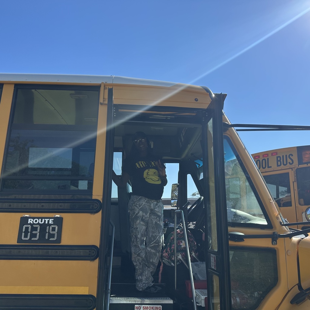 school bus driver smiling for photo for school bus driver appreciation week 