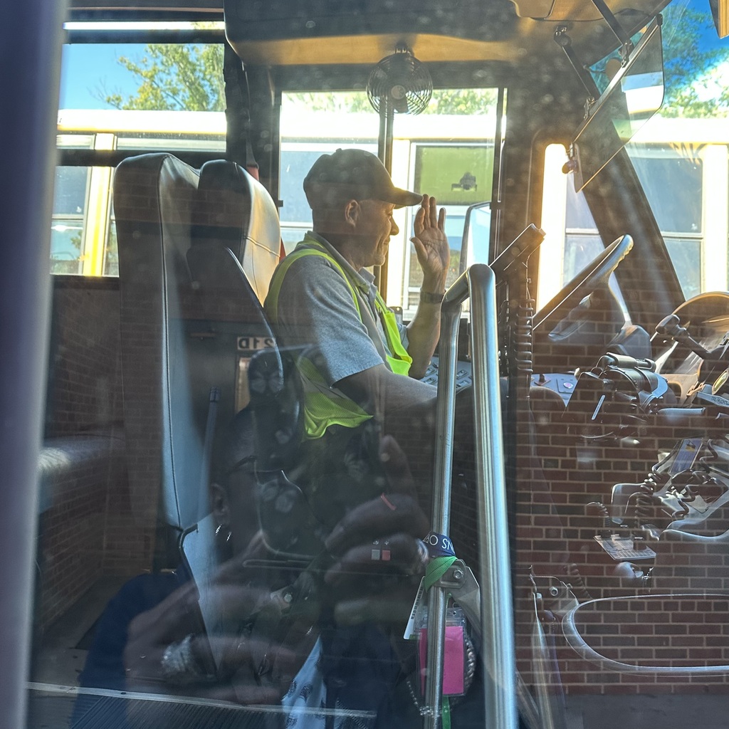 school bus driver smiling for photo for school bus driver appreciation week 