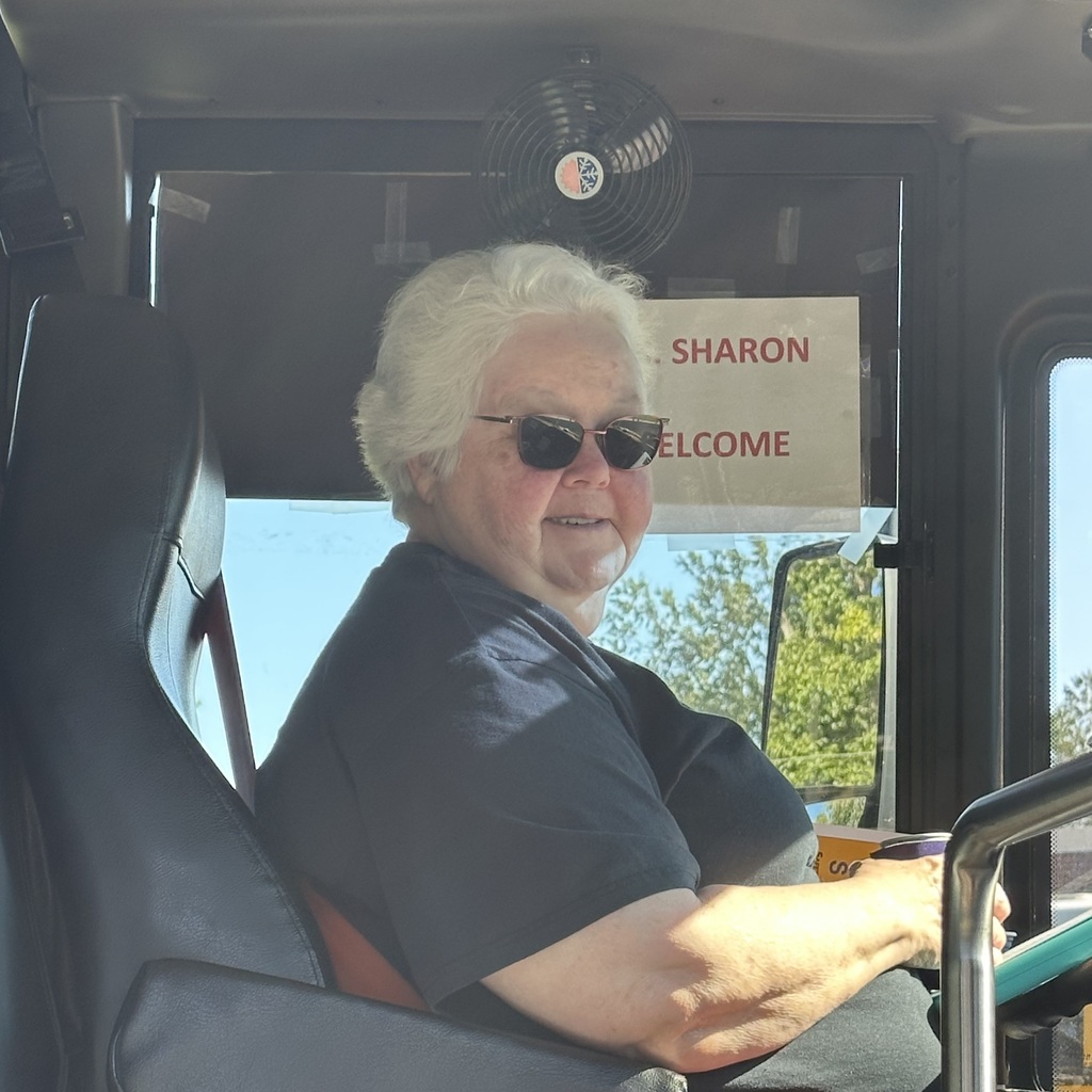 school bus driver smiling for photo for school bus driver appreciation week 
