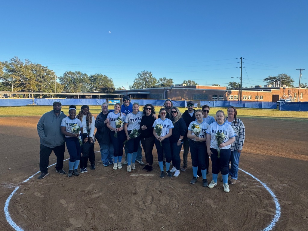 8th grade softball players with their parents, celebrating 8th grade night