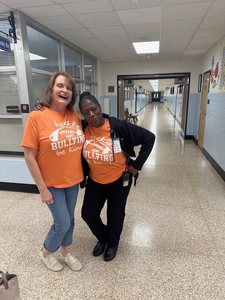 staff members standing together, wearing orange for unity day