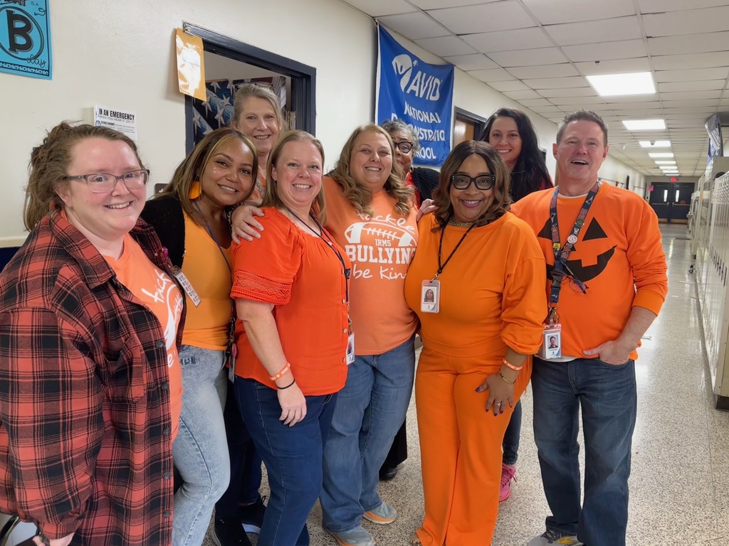 teachers standing together, wearing orange for unity day