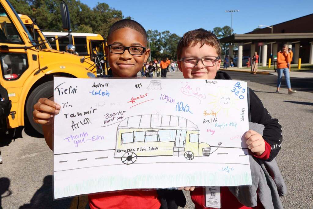 Students smile on Bus Appreciation Day