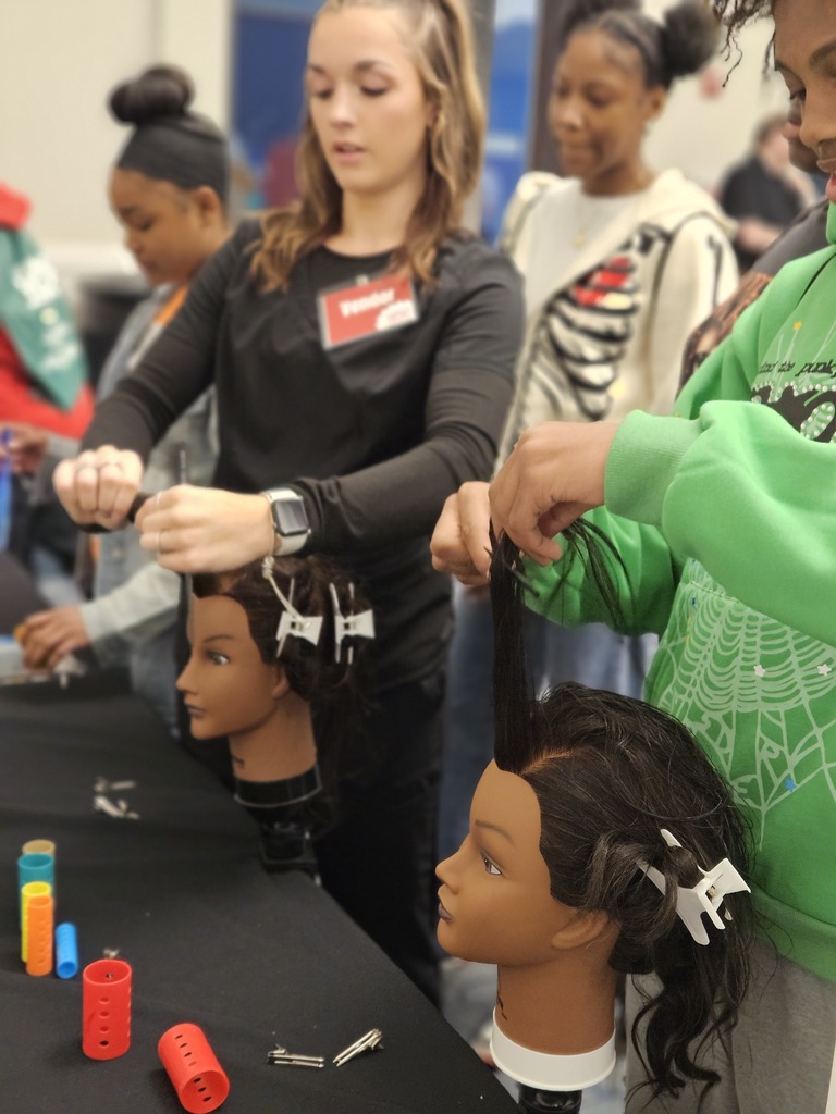 Cosmetology students at world of works showing their program to 8th graders.