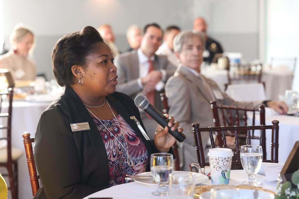 Community member speaking with others listening at the Superintendent's Community Engagement Council.