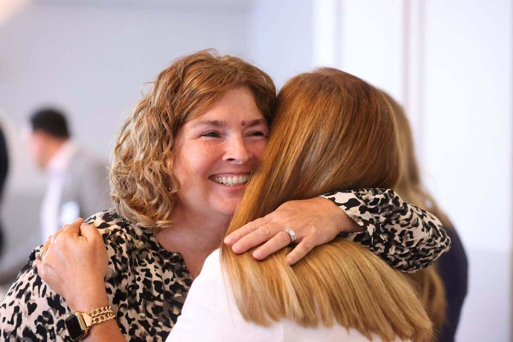 Community members hugging each other.