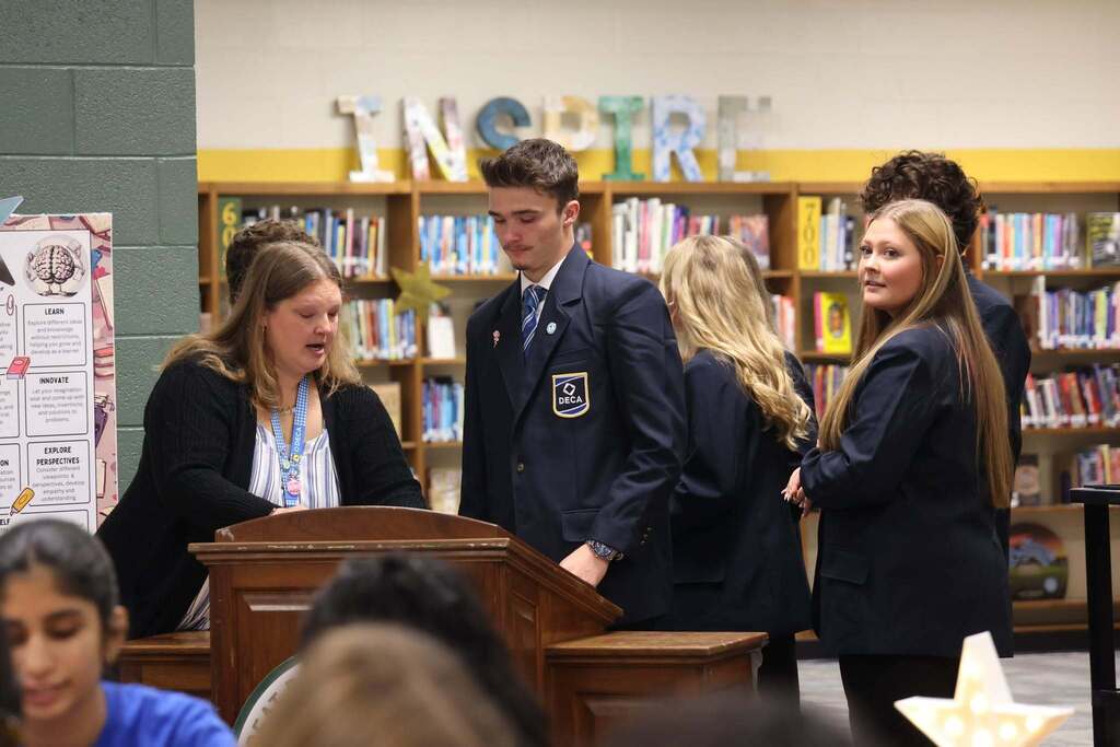 DECA students and leaders prepare to greet others