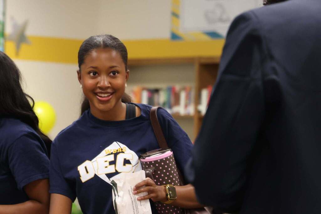 DECA student greets another