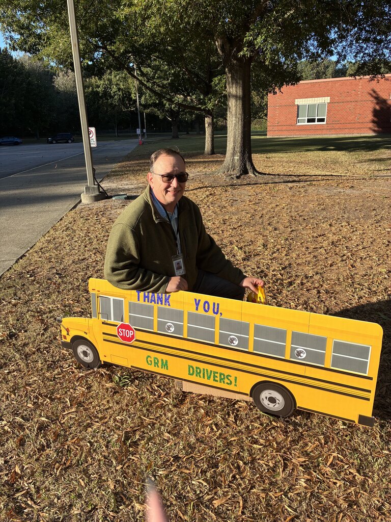 GRM Bus Drivers pose with a decorated bus