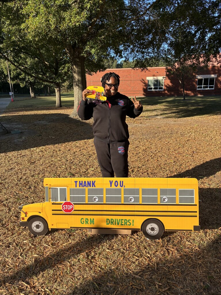 GRM Bus Drivers pose with a decorated bus