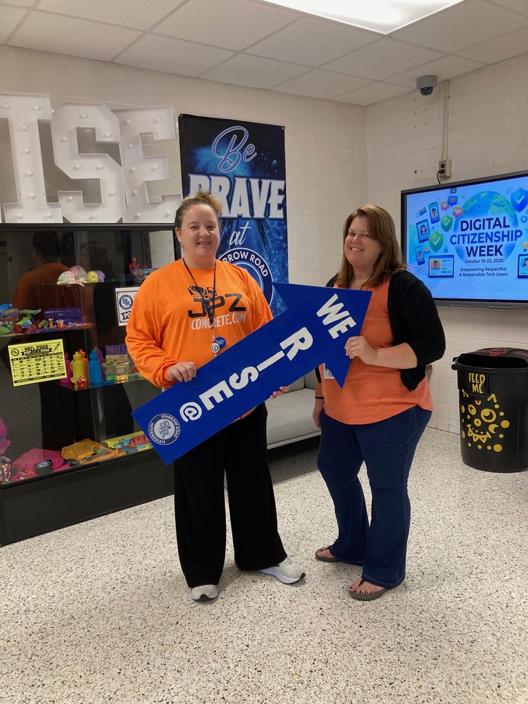 Mrs. Jarvis and Mrs. Shaughnessy holding the RISE arrow.