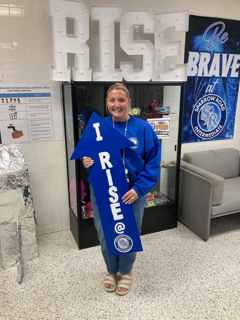Mrs. Rochevot holding the RISE arrow.