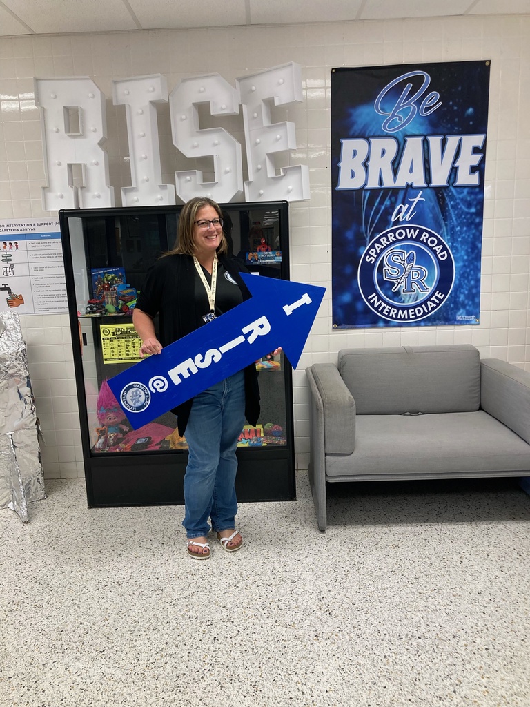 Mrs. Rapier holding the RISE arrow.
