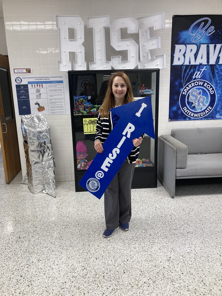 Ms. Meyers holding the RISE arrow.