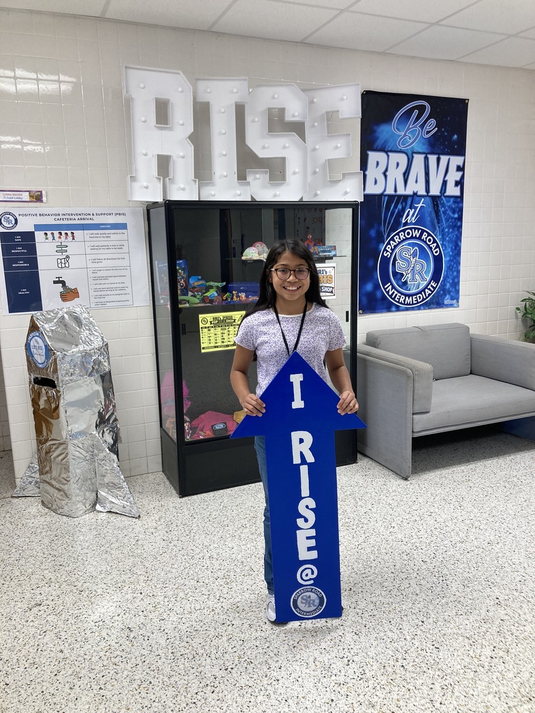 Student holding the RISE arrow.