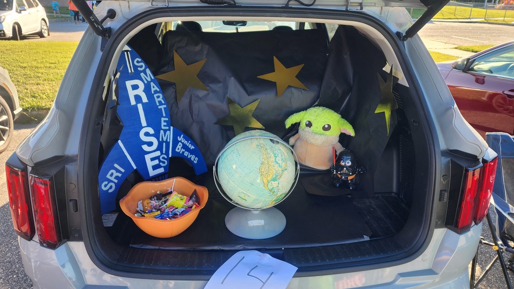 SRI Trunk or Treat close up of SMARTemis, candy, a globe, and stars.