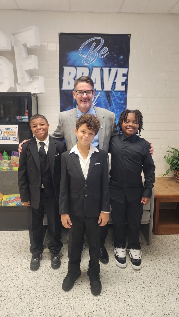 Mr. Triolet with 3 students for dressed to impress day.