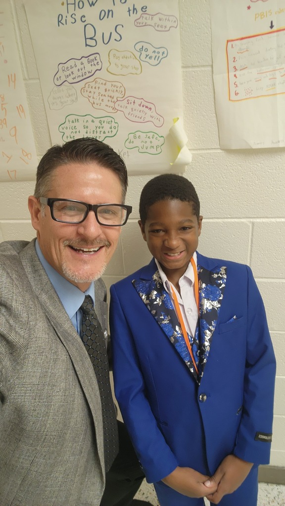 Selfie of Mr. Triolet and a student in suits.