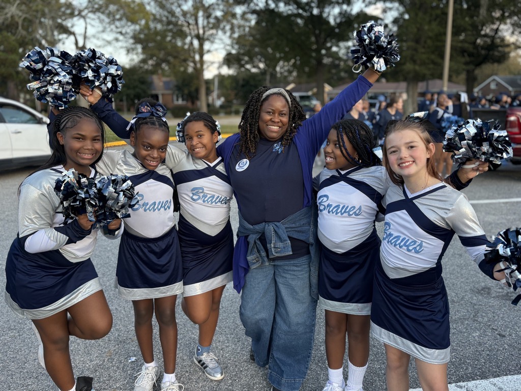 Mrs Young and the SRI Cheerleaders grouped together.