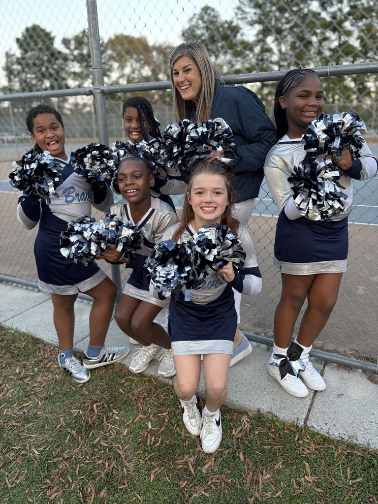 Mrs. Snow and five student cheerleaders with pom poms.