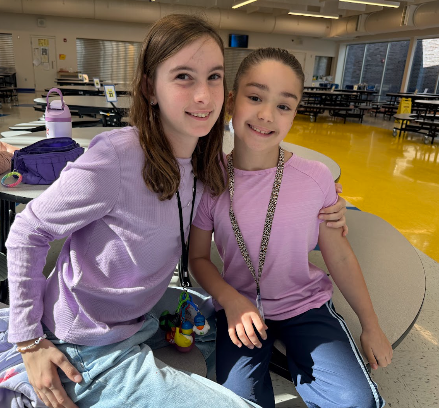 students smiling wearing pink for Breast cancer awareness