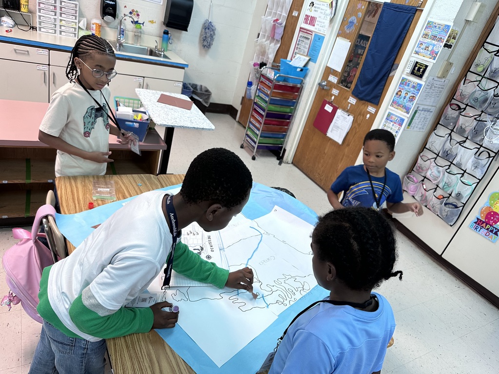 2nd graders working together to construct a map of north america
