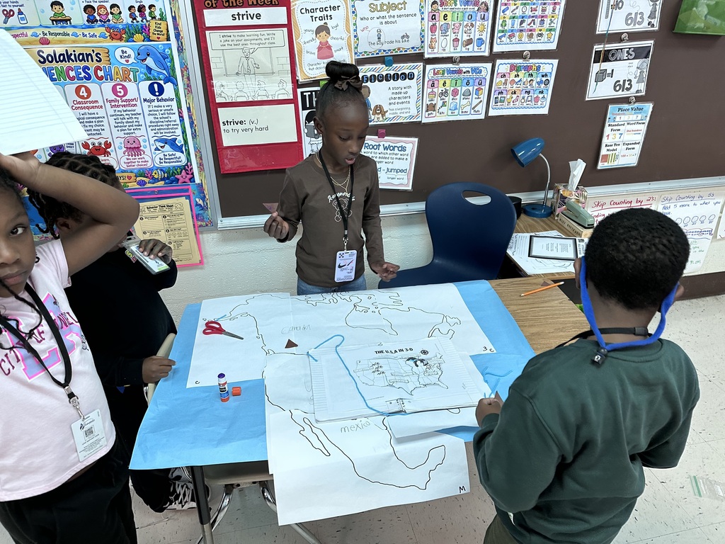 2nd graders working together to construct a map of north america