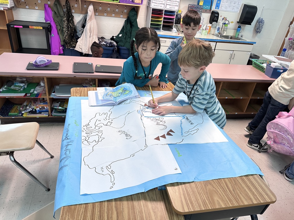 2nd graders working together to construct a map of north america