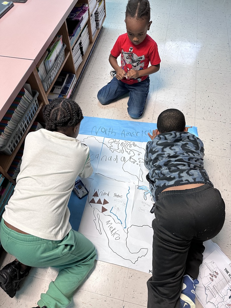 2nd graders working together to construct a map of north america