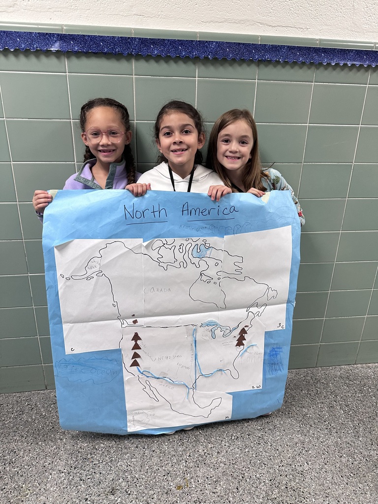 2nd graders working together to construct a map of north america