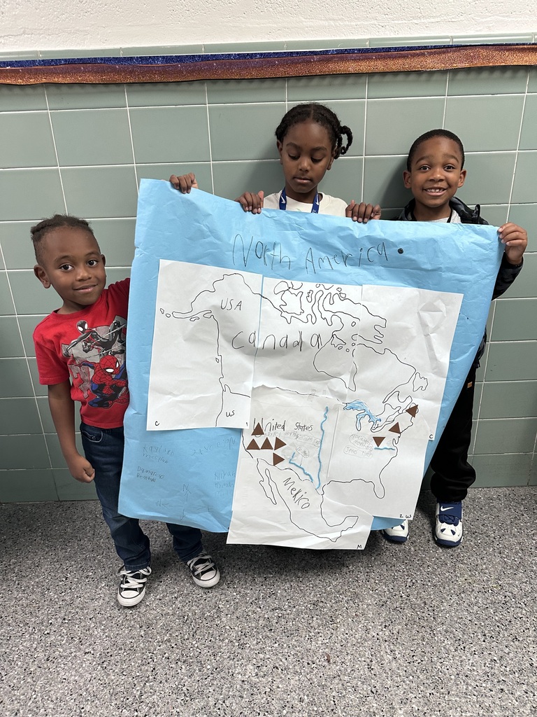 2nd graders working together to construct a map of north america