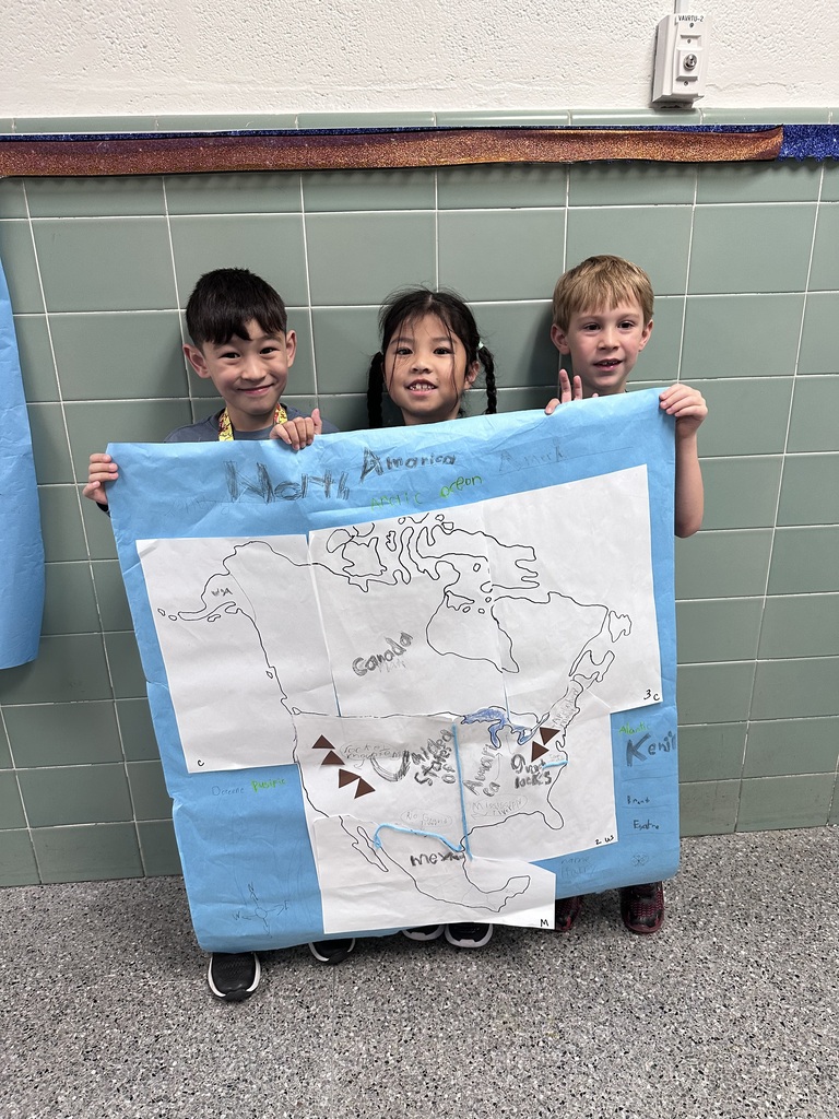 2nd graders working together to construct a map of north america