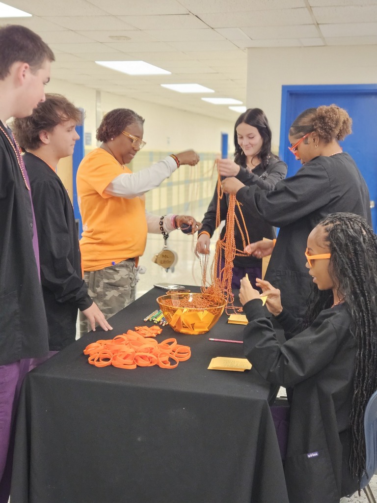 Students picking up necklaces and bracelets for unity day