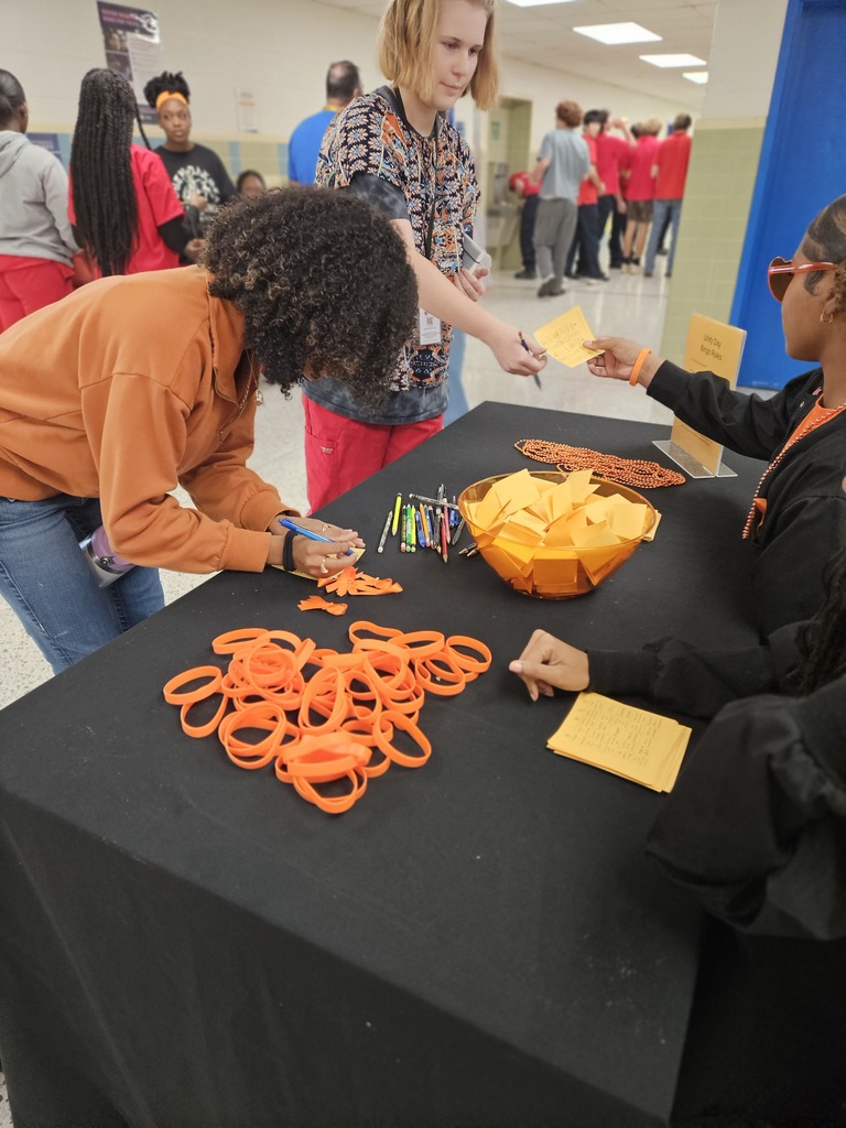 Students picking up necklaces and bracelets for unity day