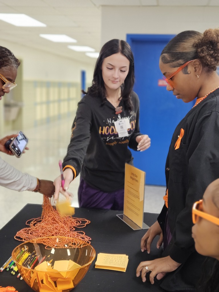 Students picking up necklaces and bracelets for unity day