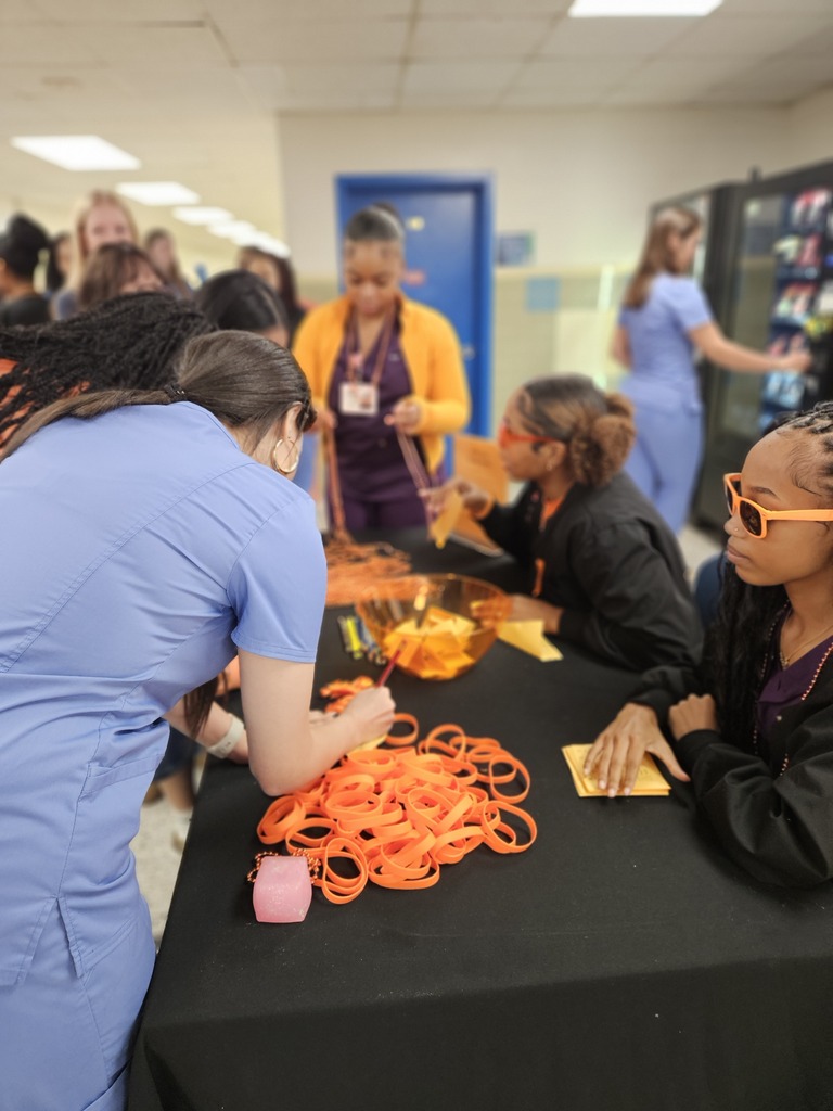 Students picking up necklaces and bracelets for unity day