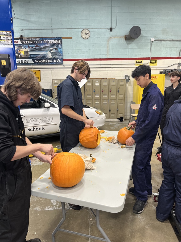 students carving their pumpkins