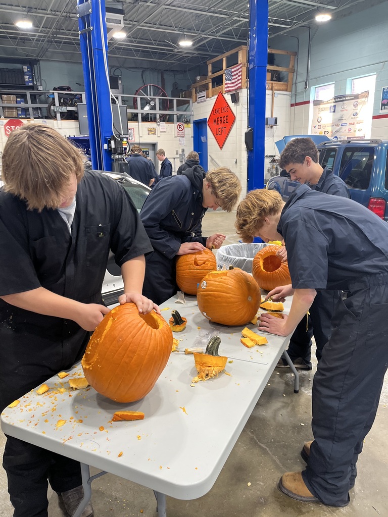 students carving their pumpkins