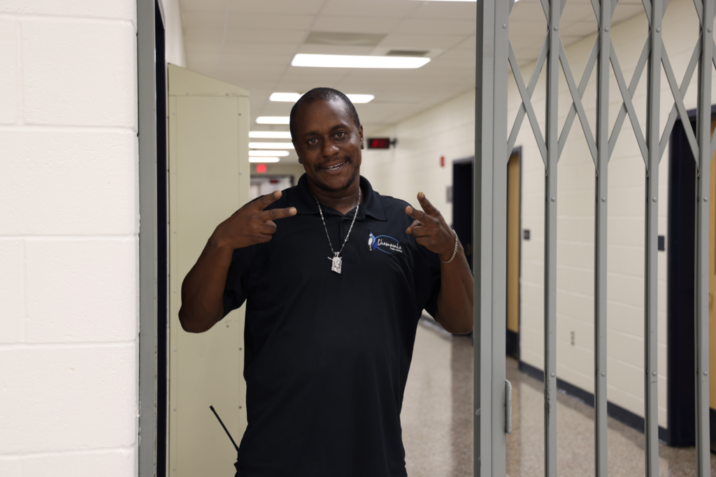 custodian giving peace signs