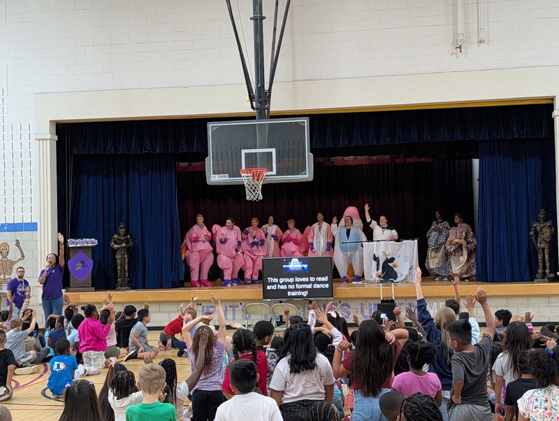 costumed staff members on stage