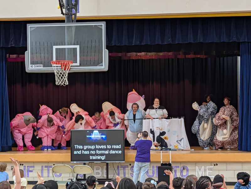 costumed staff members on stage