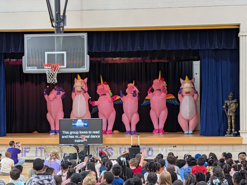costumed staff members on stage