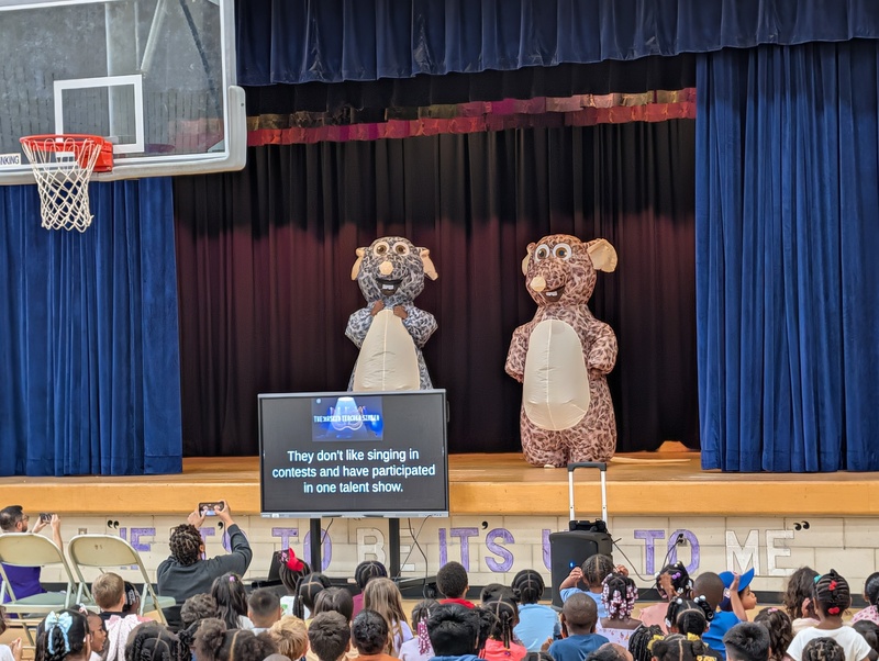 costumed staff members on stage