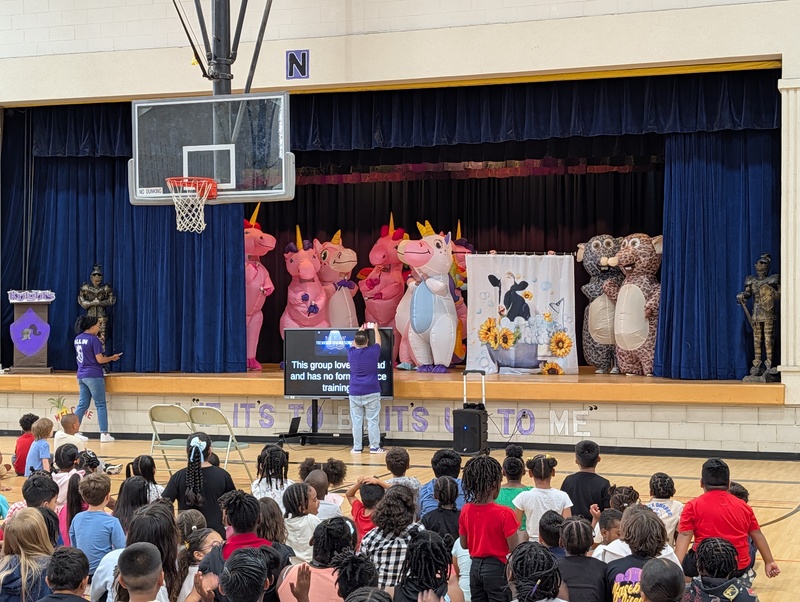 costumed staff members on stage