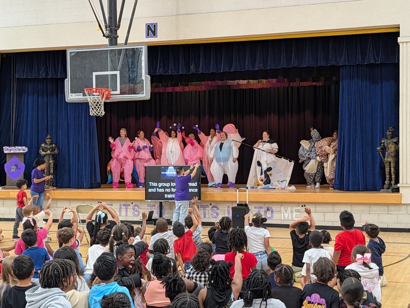 costumed staff members on stage