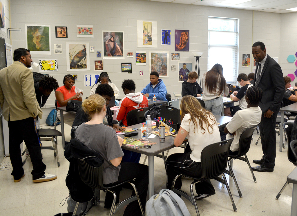 LHS, Dr Sutton visiting students.